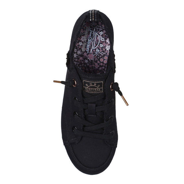 Black sneaker with floral pattern on the sole on a white background