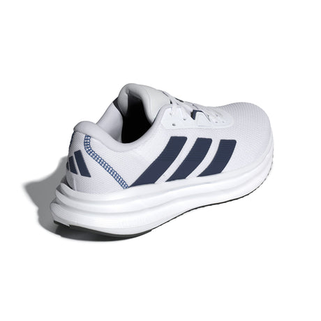 White athletic shoe with blue stripes on a white background
