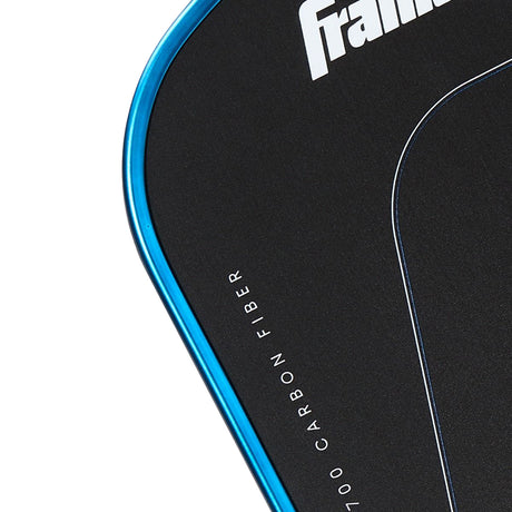 Close-up of a table tennis paddle with 'frame' branding and carbon fiber text.