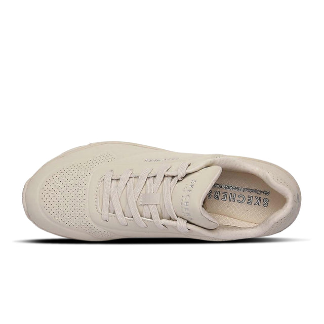 Beige sneaker with 'Skechers' branding on a white background