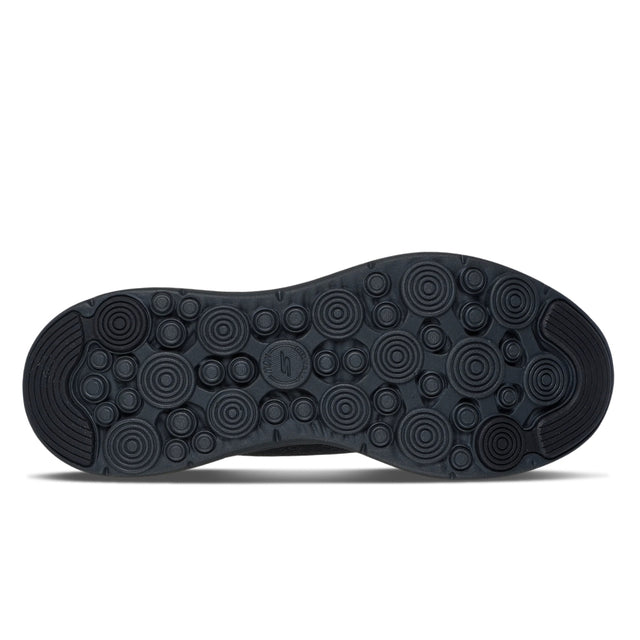 Black shoe sole with circular patterns on a white background