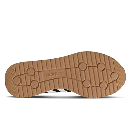 Brown sole of a shoe with Adidas logo on a white background
