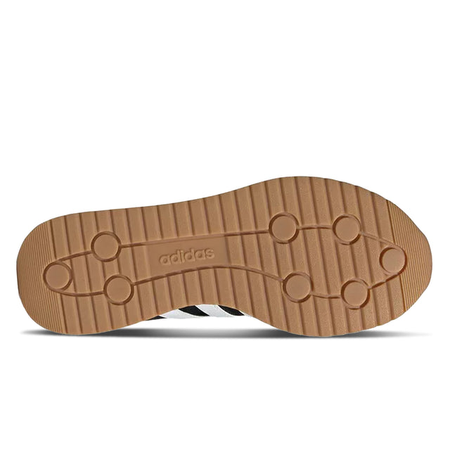 Brown sole of a shoe with Adidas logo on a white background