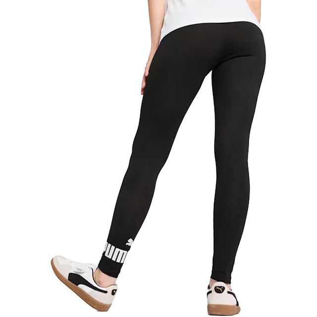 Person wearing black leggings with a white logo on a white background