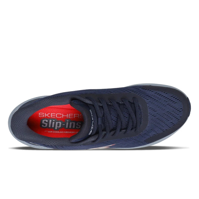 Navy blue sneaker with red interior on a white background