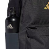 Black Adidas water bottle in a backpack pocket with Adidas logo on backpack.