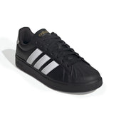 Black Adidas sneaker with white stripes on a white background