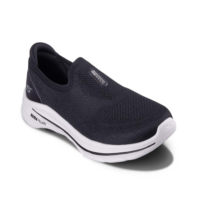 Black slip-on shoe with white sole on a white background
