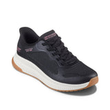 Black sneaker with brown sole on a white background