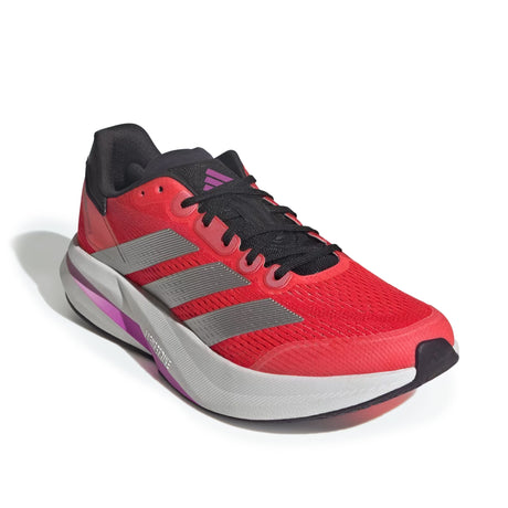 Red running shoe with black and gray accents on a white background