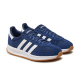 Blue Adidas sneakers with white stripes on a white background