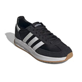 Black Adidas sneaker with white stripes on a white background