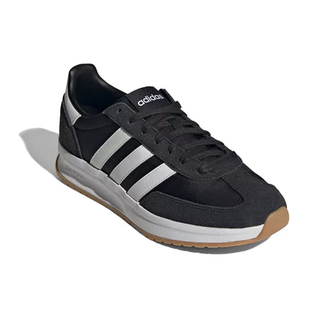 Black Adidas sneaker with white stripes on a white background