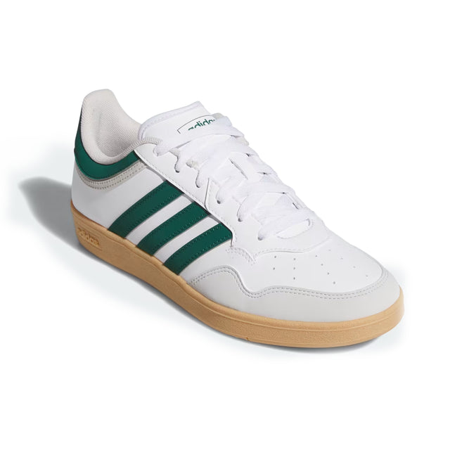 White sneaker with green stripes and brown sole on a white background