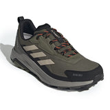 Green and black hiking shoe with brand logo on a white background