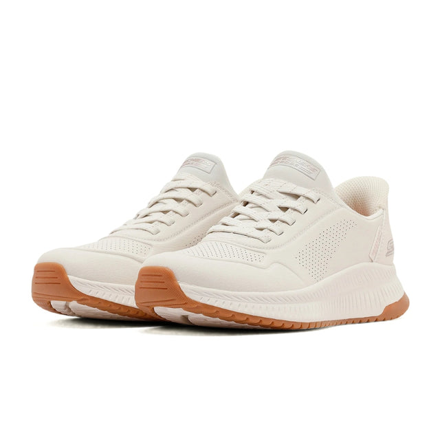 White sneakers with brown soles on a white background