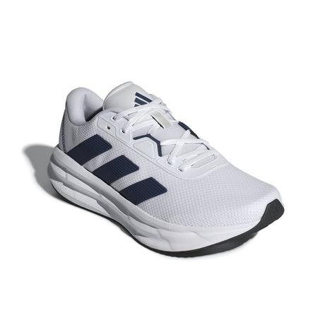 White running shoe with blue stripes on a white background