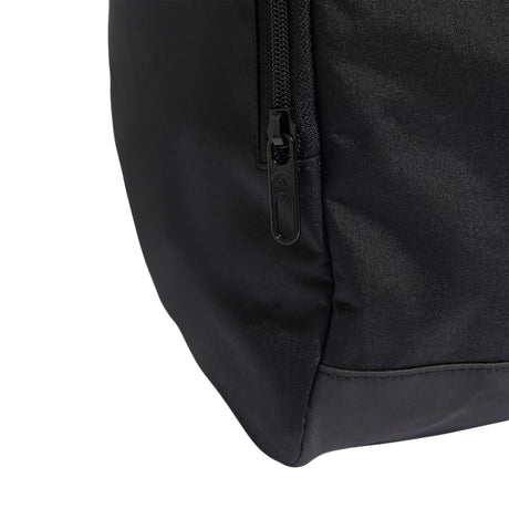 Close-up of a black backpack corner with zipper