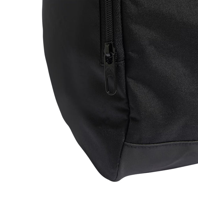 Close-up of a black backpack corner with zipper