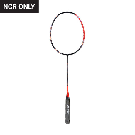 Bare frame of a Yonex Astrox 77 badminton racket with red and black color scheme, unstrung.